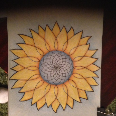 A basic Mandala circle, but where the lines meet at the edge of the circle, they extend outward to make the shapes of sunflower leaves. 