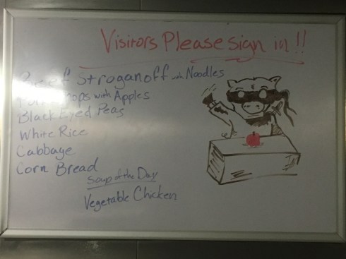 Picture of a pig wearing a ninja uniform, karate-chopping an apple on a table