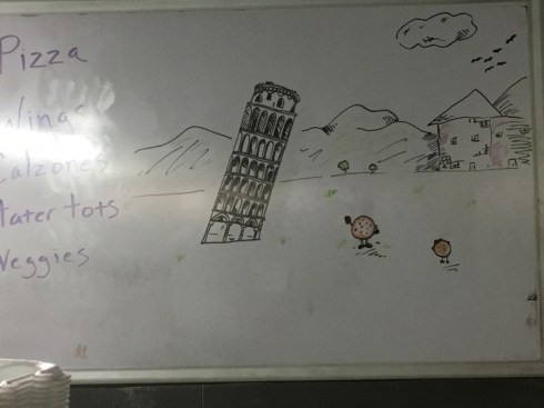 A pizza is taking a picture of another pizza, who is posing in front of the Leaning Tower of Pisa