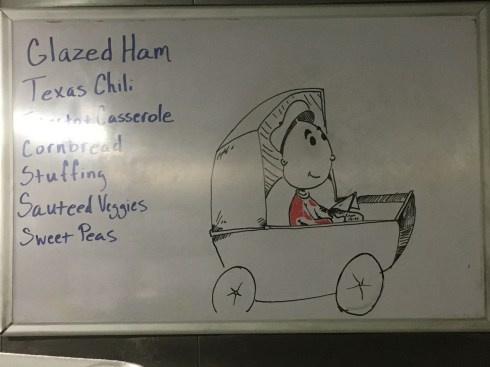 The character "Sweet Pea" from the "Popeye" franchise, who is a cute baby, sitting happily in a baby stroller